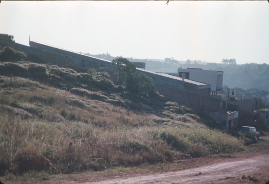 Volume longo e baixo na crista do morro, com cobertura em plano inclinado — P0006 — Residência Luiz Carlos Bresser Pereira, Jardim Guedala — F016-P0006-1967-S03-D00008