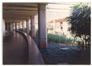 Passagem coberta por marquise de concreto apoiada em pilares, com jardim ao lado — P0015 — SESI — Ribeirão Preto