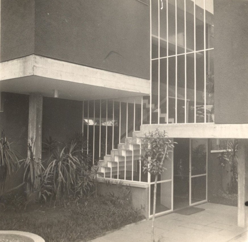 Vista de escada externa e pátio ajardinado de edificação modernista, com esquadrias de vidro e vegetação — P0001 — Residência Aecio Aeouche de Toledo — F004-P0001-1960-S03-D00005